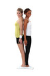 Two female gymnasts stood back to back Two female gymnasts stood back to back