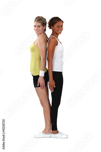 Photo: Two female gymnasts stood back to back Two female gymnasts stood back to back