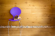 Foto: Purple chair with opened book next wooden wall / modern interior Purple chair with opened book next wooden wall / modern interior