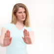 Girl with a serious look holding out her hand signaling stop