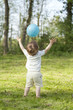 child throwing ball from back