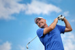 Foto: golfer shooting a golf ball golfer shooting a golf ball