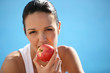 Woman biting into red apple Woman biting into red apple