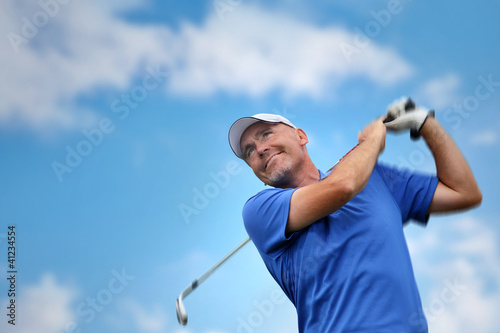 Photo: golfer shooting a golf ball golfer shooting a golf ball