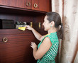 woman cleans a furniture indoor