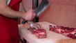 Butcher Cutting Raw Meat