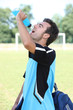 Football player drinking energy drink Football player drinking energy drink
