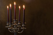 Five red candles lighted on painted room