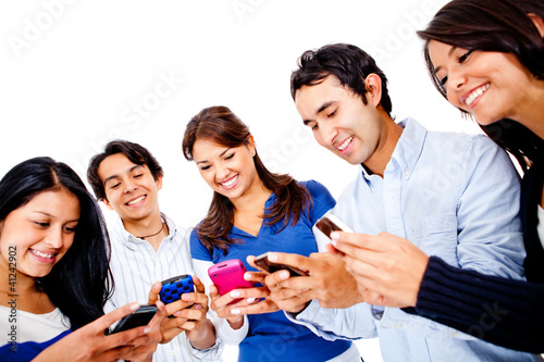 Photo: People texting on their cell phones People texting on their cell phones