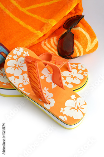 Photo: Flip-flops, sunglasses and towel Flip-flops, sunglasses and towel