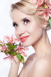 Pretty face of beautiful young woman with lily on hands - white Pretty face of beautiful young woman with lily on hands - white