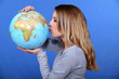 Woman kissing a globe