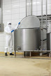 canvas print picture - technician in uniform closing  industrial process tank