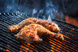 Flames frying chicken on the grill Flames frying chicken on the grill