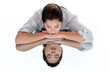 Woman with her eyes closed leaning on a mirrored table