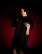 Vintage woman in retro dress on dark background. Pin-up girl