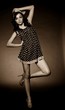 Vintage woman in retro dress on dark background. Pin-up girl