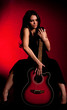 Carmen beautiful woman with guitar on dark background Carmen beautiful woman with guitar on dark background