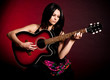 Carmen beautiful woman with guitar on dark background