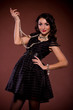 woman in retro dress on dark background. Pin-up girl