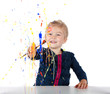 Little girl painting on window