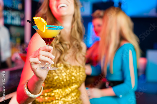 Photo: People in club or bar drinking cocktails People in club or bar drinking cocktails