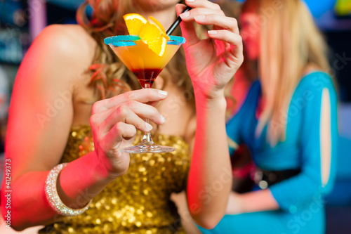 Photo: People in club or bar drinking cocktails People in club or bar drinking cocktails
