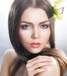Skincare of beautiful woman face with fresh flower - orchid
