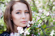 Yong pretty woman in park with blossom tree
