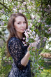 Young beautiful woman with spring blossom tree