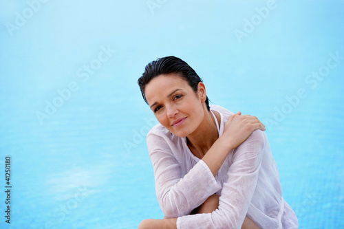 Photo: Woman near a swimming pool Woman near a swimming pool