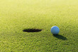 A golf ball and hole