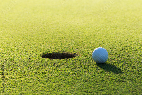 Photo: A golf ball and hole A golf ball and hole
