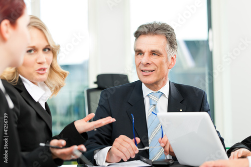 Photo: Business people - team meeting in an office Business people - team meeting in an office