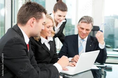 Photo: Business people - team meeting in an office Business people - team meeting in an office