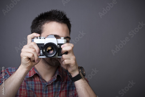 Photo: Young man with retro photo camera Young man with retro photo camera