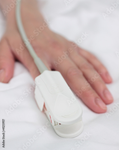 Photo: pulse oximeter on the patient's hand. Medical background. pulse oximeter on the patient's hand. Medical background.