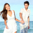 Beach couple walking happy
