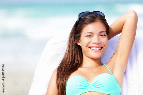 Photo: Vacation woman relaxing on sunbed Vacation woman relaxing on sunbed