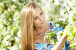 Spring woman in summer dress walking in park Spring woman in summer dress walking in park