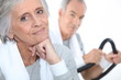 elderly lady posing in fitness center with husband