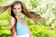 beautiful woman wearing blue dress over spring orchard beautiful woman wearing blue dress over spring orchard