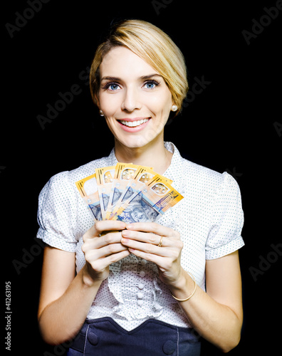 Photo: Business woman holding a cash bonanza Business woman holding a cash bonanza