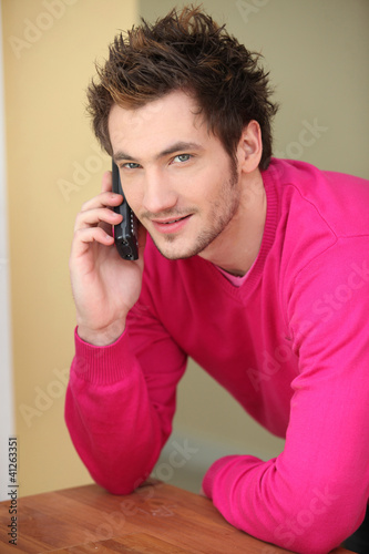 Photo: Man making a call from home Man making a call from home