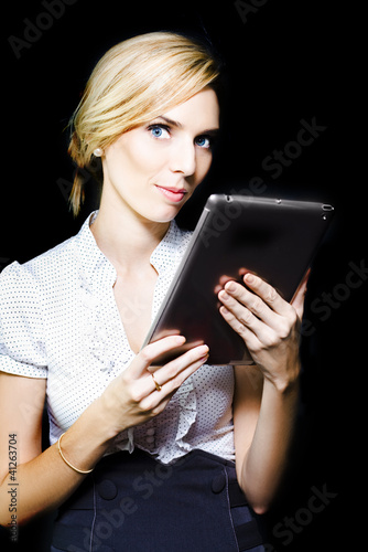 Photo: Beautiful blonde using a touch screen tablet Beautiful blonde using a touch screen tablet