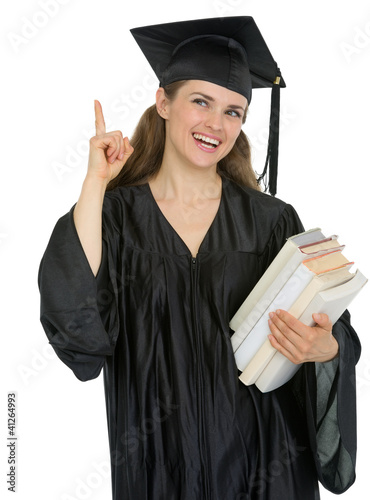 Photo: Graduation girl student with stack of books got idea Graduation girl student with stack of books got idea