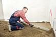 Plasterer concrete worker at floor work