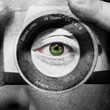 Camera painted on male face with green eyes