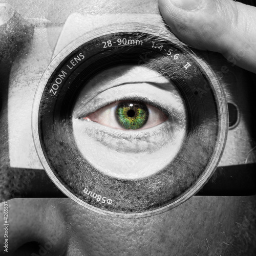 Photo: Camera painted on male face with green eyes Camera painted on male face with green eyes