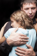 father and daughter standing together and  embracing